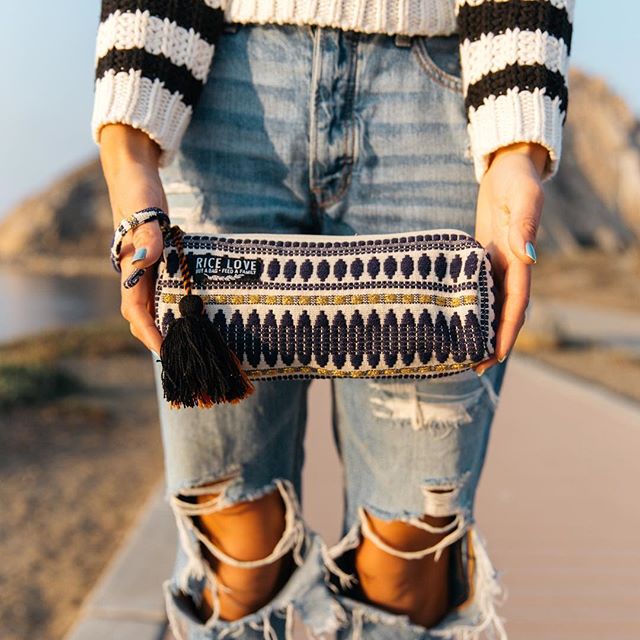Woman outdoors holding one of our stylish pouches